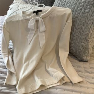 Off-white  sweater with ribbon bow tie.